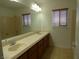 Bathroom featuring double sinks, a large mirror, and tile flooring at 6604 Octave Ave, Las Vegas, NV 89139