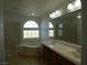 Bright bathroom featuring a large soaking tub and double vanity at 6604 Octave Ave, Las Vegas, NV 89139