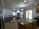 Open kitchen with island and view of the living room and sliding glass doors at 6604 Octave Ave, Las Vegas, NV 89139