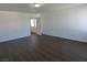 Spacious living room featuring wood-look flooring and neutral walls at 6604 Octave Ave, Las Vegas, NV 89139