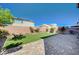 The backyard has artificial turf, planter beds, and brick-paved patio, great for relaxation and entertainment at 6790 Tangled Vines Ave, Las Vegas, NV 89139