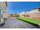 Green backyard features grass area and brick patio at 6790 Tangled Vines Ave, Las Vegas, NV 89139