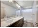 Bathroom with double sink vanity, marble countertop, and shower-tub combo at 6790 Tangled Vines Ave, Las Vegas, NV 89139