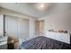 Well lit bedroom with sliding closet and a large dresser at 6790 Tangled Vines Ave, Las Vegas, NV 89139