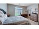 Comfortable bedroom with natural light, plush bedding, and stylish wood furnishings at 6790 Tangled Vines Ave, Las Vegas, NV 89139