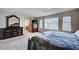 Bedroom features a decorative dresser and mirror with a view to the bathroom at 6790 Tangled Vines Ave, Las Vegas, NV 89139