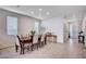 Bright dining room with wood flooring, a decorative table, and window coverings at 6790 Tangled Vines Ave, Las Vegas, NV 89139