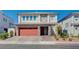 A charming two-story home with a paver driveway and a red two-car garage at 6790 Tangled Vines Ave, Las Vegas, NV 89139