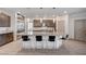 A spacious kitchen with granite countertops, pendant lighting, and a large center island with seating at 6790 Tangled Vines Ave, Las Vegas, NV 89139