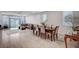 A combined living and dining area with modern furnishings and wood-look flooring at 6790 Tangled Vines Ave, Las Vegas, NV 89139