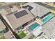 An aerial view of the home with a pool, artificial turf, and solar panels on the roof at 716 Cadence View Way, Henderson, NV 89011