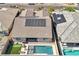 An aerial view of the home with a pool, artificial turf, and solar panels on the roof at 716 Cadence View Way, Henderson, NV 89011