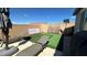 Backyard with lounge chairs, basketball hoop and netting with artificial grass at 716 Cadence View Way, Henderson, NV 89011