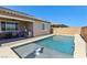 Lovely backyard featuring a sparkling private pool, a built-in bar stool, and a covered patio at 716 Cadence View Way, Henderson, NV 89011