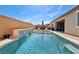 Beautiful backyard with a private pool and waterfall, complete with lounge chairs and covered patio area at 716 Cadence View Way, Henderson, NV 89011