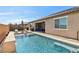 Stunning backyard with a sparkling pool, sun loungers, and a covered patio for ultimate relaxation at 716 Cadence View Way, Henderson, NV 89011