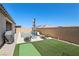 Relaxing backyard featuring a private pool, artificial grass, and lounge area for outdoor enjoyment at 716 Cadence View Way, Henderson, NV 89011