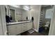 Bathroom boasts a double vanity, modern fixtures, and a shower with a striped curtain at 716 Cadence View Way, Henderson, NV 89011