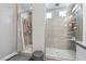 Bathroom with walk-in shower featuring tile surround and glass enclosure, next to shower behind curtain at 716 Cadence View Way, Henderson, NV 89011