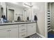 Bathroom featuring a double sink vanity with framed mirror and a shower and tub combo behind a curtain at 716 Cadence View Way, Henderson, NV 89011