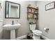 Charming powder room featuring a pedestal sink and decorative shelving adding a touch of whimsy to the space at 716 Cadence View Way, Henderson, NV 89011