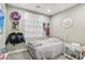 Bedroom with white-painted walls, white trim, a metal framed bed and decorative wall hangings at 716 Cadence View Way, Henderson, NV 89011