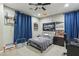 Bedroom with a black metal frame bed, work desk and chair and decorative sports themed decorations at 716 Cadence View Way, Henderson, NV 89011