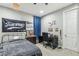 Bedroom with a black metal frame bed, work desk and chair and decorative sports themed decorations at 716 Cadence View Way, Henderson, NV 89011
