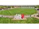 Community space featuring a sign that says 'It All Starts Here' on lush green grass with a lake at 716 Cadence View Way, Henderson, NV 89011