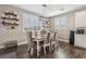 Formal dining area featuring a wooden table, upholstered chairs, and natural light from window at 716 Cadence View Way, Henderson, NV 89011