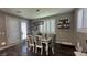 Bright dining area with modern light fixture, shutters, and access to the backyard at 716 Cadence View Way, Henderson, NV 89011