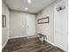 Inviting entryway featuring hardwood floors, a bench, and decorative wall art that reads, 
