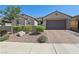 Charming single-story home with desert landscaping, low wall, and a two-car garage at 716 Cadence View Way, Henderson, NV 89011