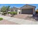Charming single-story home featuring a two-car garage, low wall, and desert landscaping at 716 Cadence View Way, Henderson, NV 89011