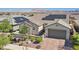 Inviting single-story home featuring a desert landscape, two-car garage, and solar panels at 716 Cadence View Way, Henderson, NV 89011