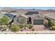 Inviting single-story home featuring a desert landscape, two-car garage, and solar panels at 716 Cadence View Way, Henderson, NV 89011