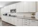 Modern kitchen featuring white cabinets, subway tile backsplash, stainless steel appliances, and granite countertops at 716 Cadence View Way, Henderson, NV 89011