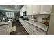 Bright kitchen with white cabinets, quartz countertops, and stainless steel appliances at 716 Cadence View Way, Henderson, NV 89011