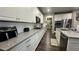 Spacious kitchen featuring granite countertops, modern appliances, and white cabinetry at 716 Cadence View Way, Henderson, NV 89011
