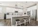 Spacious kitchen featuring an island, white cabinets, stainless steel appliances, and bar stool seating at 716 Cadence View Way, Henderson, NV 89011