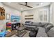 Living room with a sectional sofa, ceiling fan, television and console table, and hardwood floors at 716 Cadence View Way, Henderson, NV 89011