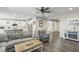 Open-concept living area connected to kitchen with hardwood floors, modern furniture, and neutral paint at 716 Cadence View Way, Henderson, NV 89011