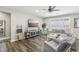 Open-concept living room with hardwood floors, large sofa, TV and entertainment center at 716 Cadence View Way, Henderson, NV 89011