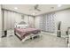 Bedroom featuring neutral walls, carpeted floors, ceiling fan, a bed with upholstered headboard and floral curtains at 716 Cadence View Way, Henderson, NV 89011