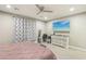 Bedroom featuring neutral walls, carpeted floors, ceiling fan, television, dresser and comfortable furnishings at 716 Cadence View Way, Henderson, NV 89011