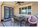 Outdoor patio featuring a dining table set and blue-trimmed sliding doors, creating an inviting space at 716 Cadence View Way, Henderson, NV 89011
