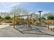 Unique playground featuring a wooden climbing structure and rubberized safety surface at 716 Cadence View Way, Henderson, NV 89011
