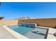 Private backyard pool with a modern waterfall feature, surrounded by brick walls and manicured landscaping at 716 Cadence View Way, Henderson, NV 89011
