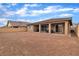 View of the backyard showing the covered patio, ample space, and privacy wall at 741 Monroe Hill Pl, Henderson, NV 89011