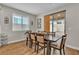 Cozy dining room featuring a wooden table, comfortable seating, and natural light from a window at 741 Monroe Hill Pl, Henderson, NV 89011